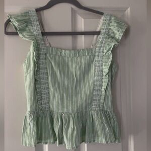 size small green top; kinda cropped, definitely appropriate for things like work